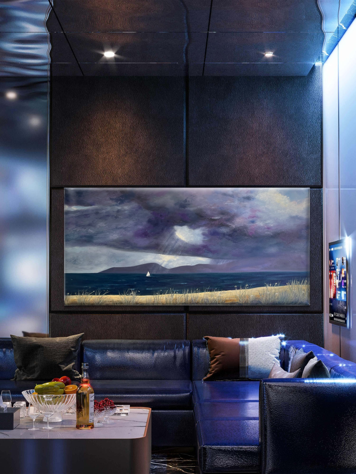 A framed landscape original oil painting of a stormy sea under a purple and gray sky, displayed on a dark wall above a blue leather sectional sofa in a modern room.