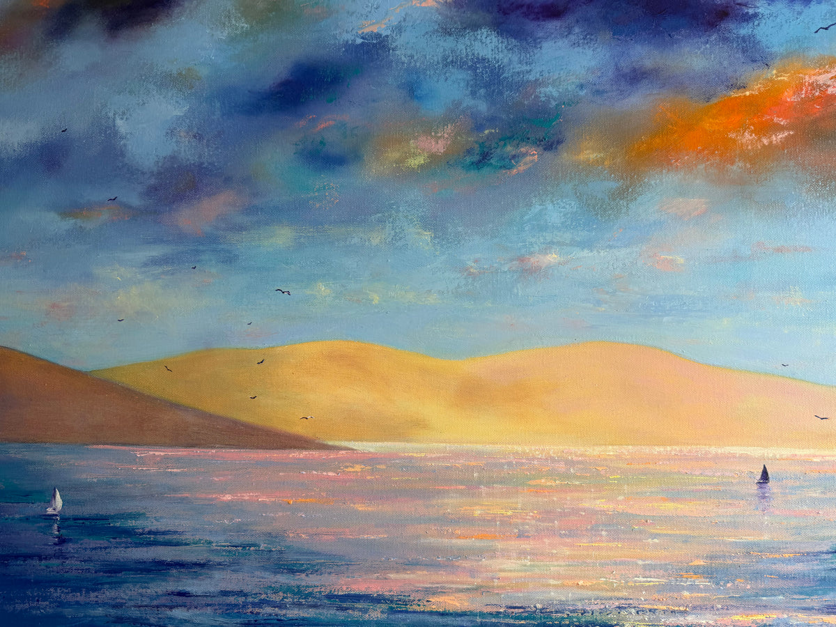 A colorful landscape painting of a seascape at sunset, featuring golden sand dunes, blue and purple water, and a dramatic cloudy sky with orange and teal tones.