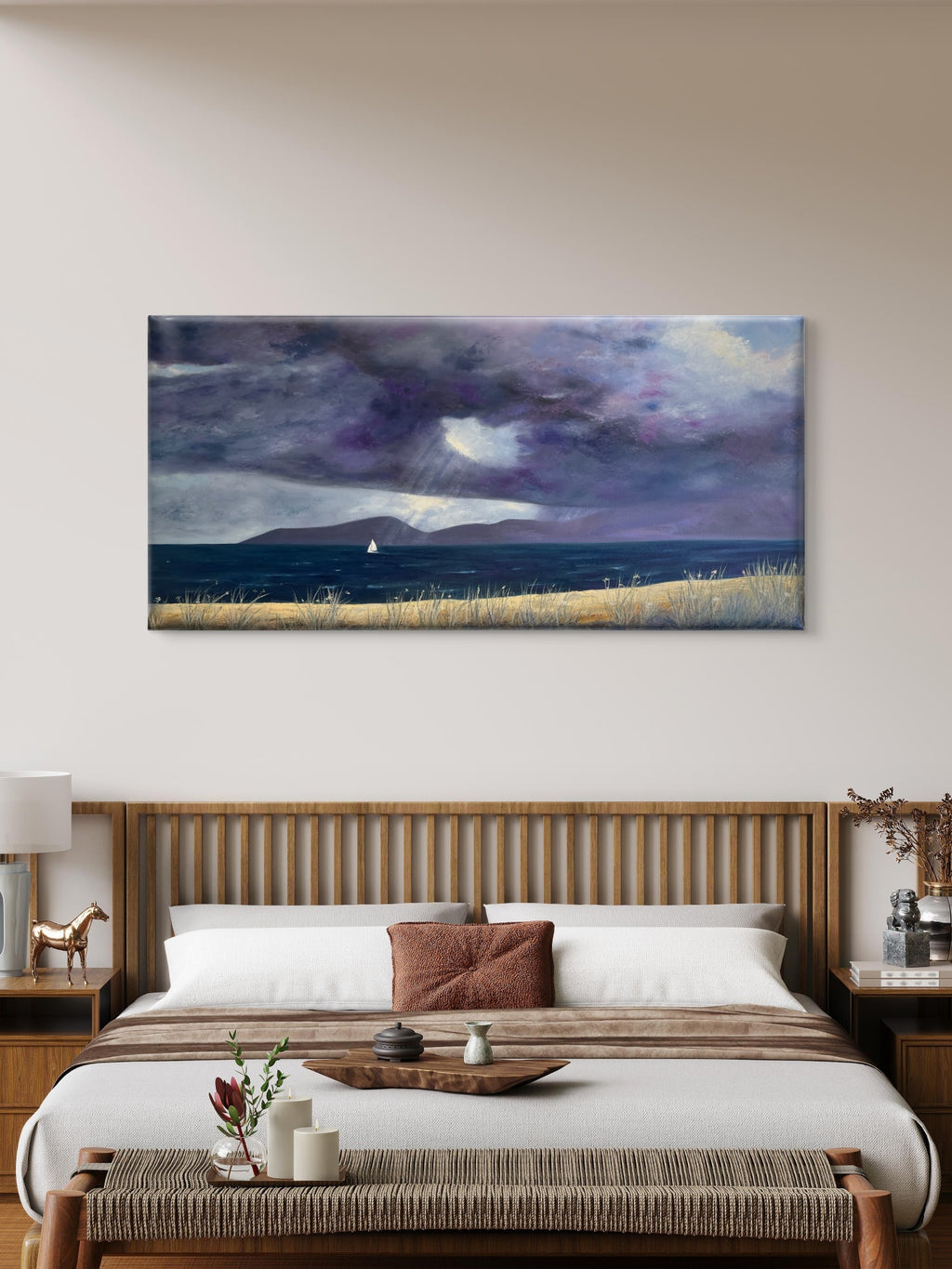 A panoramic canvas original oil painting depicting a dramatic stormy seascape with dark purple and gray clouds, a small sailboat on the horizon, and a golden grassy field, displayed in a modern bedroom setting above a wooden bed.